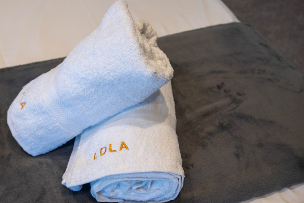 9 towels rolled on the sofe